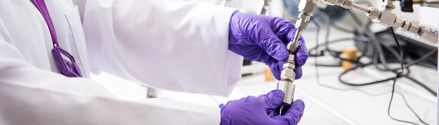 Anonymous hands adjusting machinery in laboratory